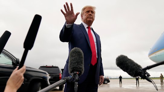 US President Donald Trump walks away from the media to board Air Force One for a trip to a campaign rally in Michigan.
