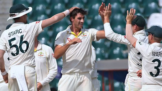 Australian captain Pat Cummins celebrates a Pakistan wicket with teammates on the final day of the third Test.