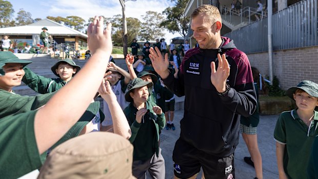 Tom Trbojevic is mobbed by students during a visit to his old school, Mona Vale Public, on Tuesday.