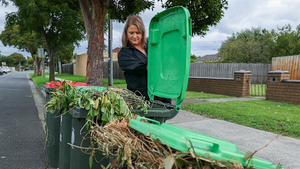 Jacky Stibilj inspects full bins in her neighbourhood which have not been collected.