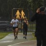 Signs on the Bay Run at Lilyfield remind exercisers to socially distance on Monday.