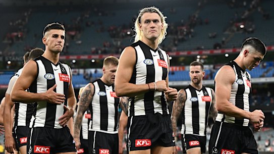 The Magpies look dejected after losing the round one AFL match against the Sydney Swans at the MCG.