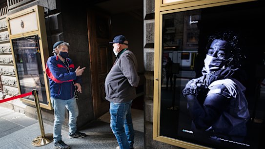 Peer support worker Jimmy Rose (right) chats to his friend, Greg, outside Melbourne’s new vaccine centre dedicated to the city’s homeless and disadvantaged.