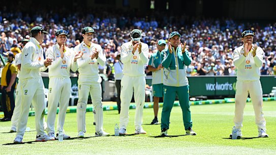 Justin Langer applauding with the Australia team as Scott Boland is awarded the Mullagh Medal.