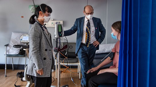 Professor Steven Faux and Dr Morgan Hee (left) meet with long COVID patient Payton Jacobs in March.