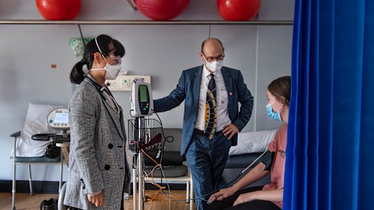 Professor Steven Faux and Dr Morgan Hee (left) meet with long COVID patient Payton Jacobs in March.
