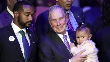 Democratic presidential candidate and former New York City mayor Michael Bloomberg is joined on stage by supporters during his campaign launch of "Mike for Black America," at the Buffalo Soldiers National Museum in Houston. 