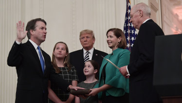  Supreme Court Justice Brett Kavanaugh is sworn in as Donald Trump looks on, in the East Room of the White House.