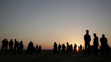 The sun sets over Palestinian protesters gathered at the Gaza Strip border with Israel.