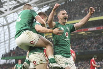 Ireland’s Jonathan Sexton, right celebrates with Ireland’s Andrew Conway, left and try scorer Ireland’s Garry Ringrose, after Ringrose scores a try , during the Six Nations rugby union match between Ireland and Wales at the Aviva stadium.