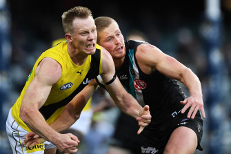 Richmond's Jack Riewoldt, left, and Port Adelaide's Tom Clurey, right, grimace in the hard-fought contest.