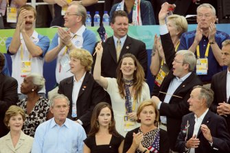Former prime minister Kevin Rudd and Sports minister Kate Ellis sit behind the Bush family at the Beijing 2008 Winter Olympics. 