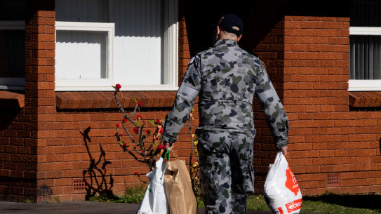 A Defence Force member delivers groceries to people in isolation during Sydney’s lockdown mid-2021.