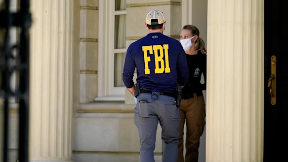 Federal agents stand outside a home of Russian oligarch Oleg Deripaska in Washington, DC.