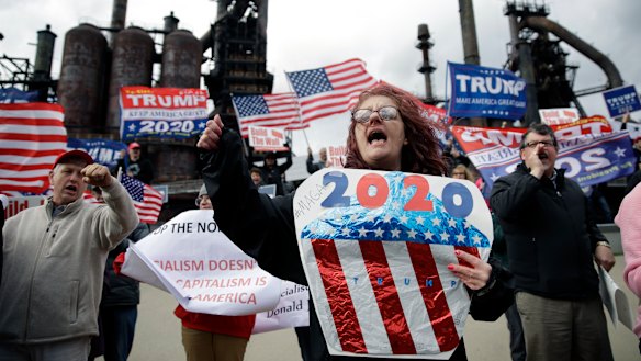Protesters demonstrate in support of US President Donald Trump near a Fox News town-hall style event with Senator Bernie Sanders on Monday.