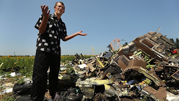 Donetsk People's Republic sniper Eugene Lukovkin stands among pilots' bags where he witnessed the front section of MH17 crashing and found the pilots bodies.