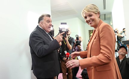 Craig Kelly and Tanya Plibersek argue in the hallway of Parliament House on Wednesday.