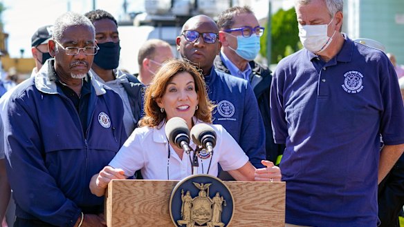 New York Governor Kathy Hochul, centre is joined by Mayor Bill de Blasio, right, during a news conference near a home where people were killed when their basement apartment was flooded in the Jamaica neighbourhood of Queens.