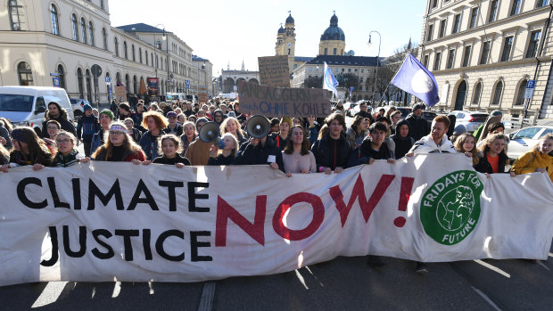 Fridays for Future protesters march through Munich's centre after a protest outside the headquarters of German engineering conglomerate Siemens which has a contract to provide systems to the Adani mine in Queensland.