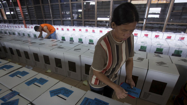 Workers prepare ballot boxes for distribution ahead of April 17 elections in Medan, North Sumatra, Indonesia.