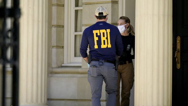 Federal agents stand outside a home of Russian oligarch Oleg Deripaska in Washington, DC.