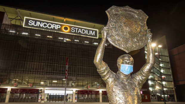 The Wally Lewis statue is seen wearing a COVID-19 mask outside Suncorp Stadium.