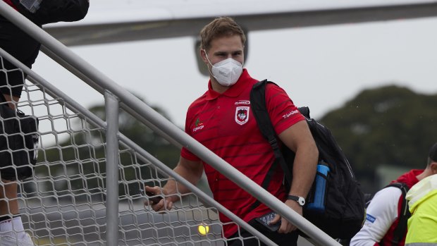 Jack de Belin boards a flight to Queensland with his Dragons teammates on Wednesday.
