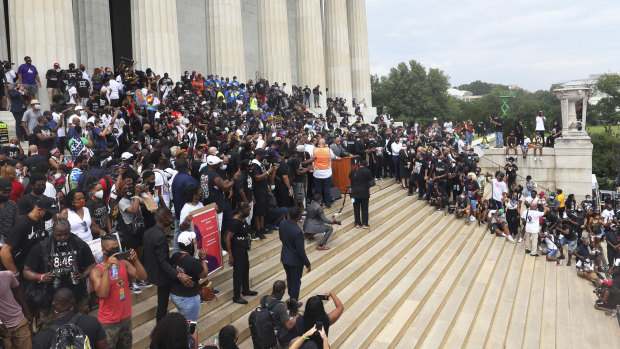 People gather at the Lincoln Memorial as they listen to the Rev. Al Sharpton speak during the March on Washington.