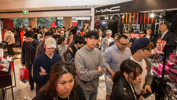 Shoppers pour into David Jones as the doors open. 