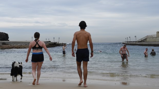 People practise social distancing during a morning swim at Clovelly Beach.