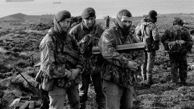 Royal Marines wait to go on patrol from Ajax Bay during the Falklands War.