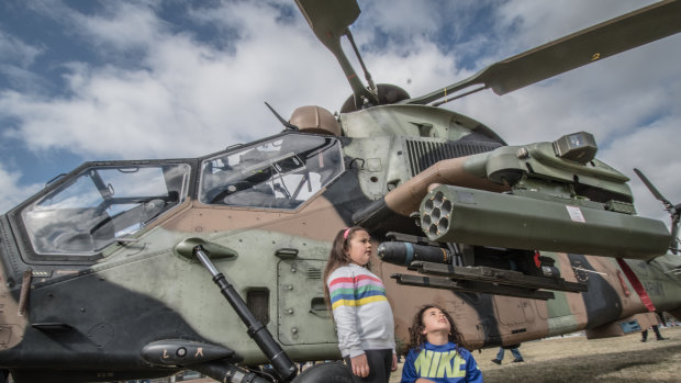 William Webb-Maloney, 8, and his sister Beth, 6, of Theodore, check out the rocket launcher on the ARH Tiger helicopter.