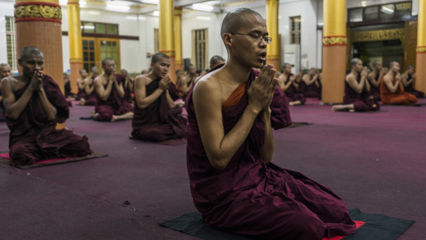 Monks pray in the Bengala monastery in Yangon, Myanmar.