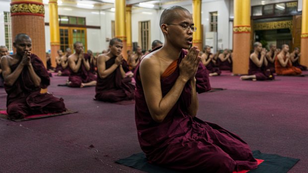 Monks pray in the Bengala monastery in Yangon, Myanmar.