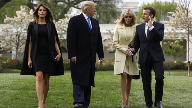 Caped crusader ... Melania Trump (left) with President Donald Trump, French First Lady Brigitte Macron and French President Emmanuel Macron.