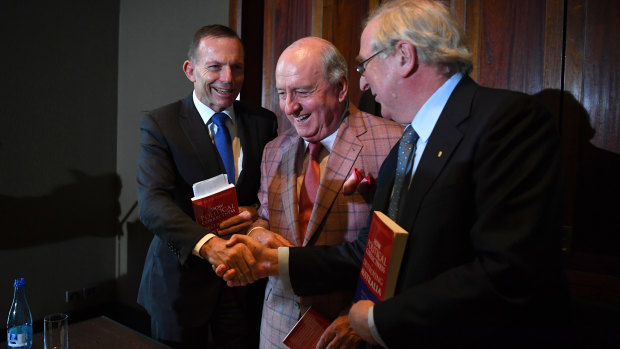 Former prime minister Tony Abbott, left,  shakes hands with Kevin Donnelly, right, as radio host Alan Jones looks on..