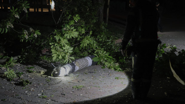 Police officers investigate fragments of a rocket that fell down in a city zoo after it was shot down by air defense system during the night in Kyiv, Ukraine.