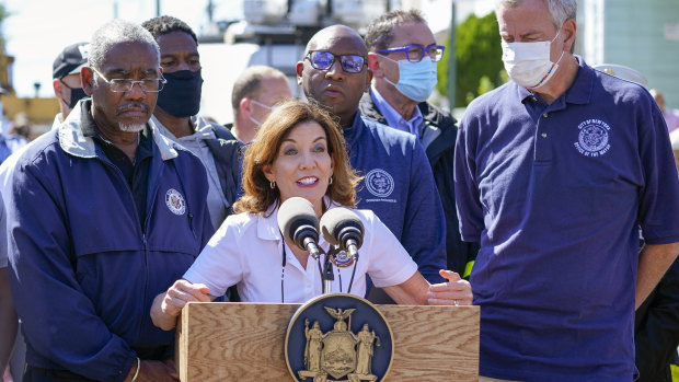 New York Governor Kathy Hochul, centre is joined by Mayor Bill de Blasio, right, during a news conference near a home where people were killed when their basement apartment was flooded in the Jamaica neighbourhood of Queens.