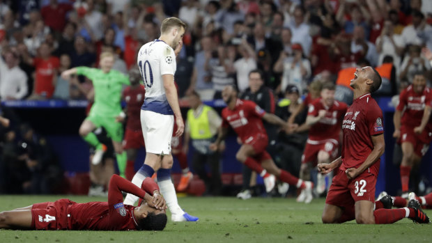 Agony, ecstasy: Harry Kane slumps off the pitch while Liverpool players celebrate.