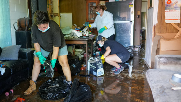 Volunteers help clean up the home of Lynne Flannigan in Stratford, Cairns.