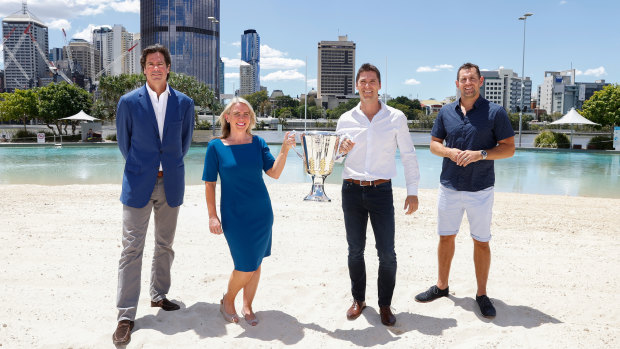 AFL chief executive Gillon McLachlan, Queensland Tourism Minister Kate Jones, former Brownlow Medallist and Brisbane Lions player Simon Black, and former Hawthorn and Brisbane Lions player Luke Hodge with the AFL premiership trophy at South Bank in Brisbane.
