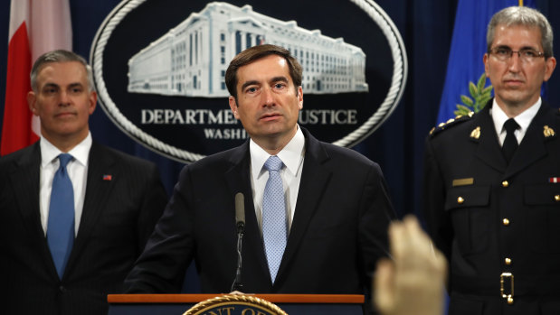 Assistant Attorney-General for National Security John Demers, centre, answers questions during a news conference.
