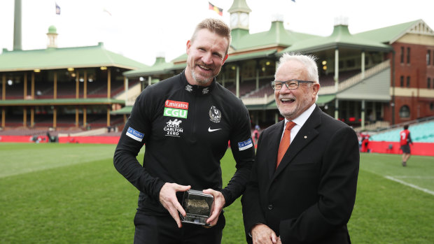 Magpies head coach Nathan Buckley receives a piece of SCG turf from Tony Shepherd.