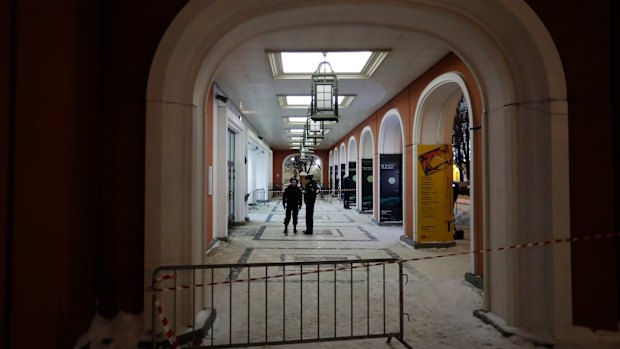 Russian police officers stand at an entrance of the Tretyakov State Gallery museum in Moscow.