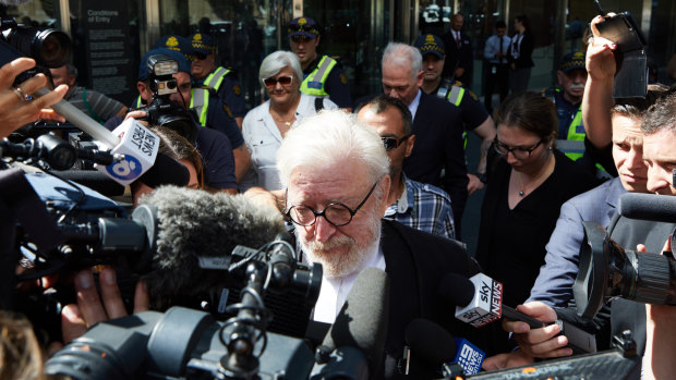 George Pell's barrister Robert Richter, QC, is surrounded by the media as he leaves court on Wednesday.