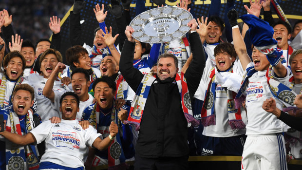Ange Postecoglou raises the 2019 J-League trophy in triumph in Yokohama.