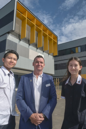 Homestead students Ameli Blake and Hayden Chan with founding school principal Michael Fawcett at the school grounds in Point Cook.