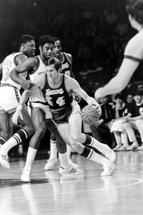 Los Angeles Lakers’ Jerry West (44) drives around Milwaukee Bucks’ Oscar Robertson and Curtis Perry during the NBA playoffs in Milwaukee, April 14, 1972.