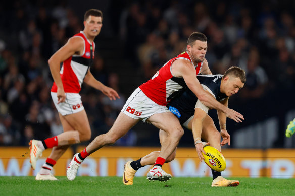 Patrick Cripps is tackled by the Saints’ Brad Crouch.