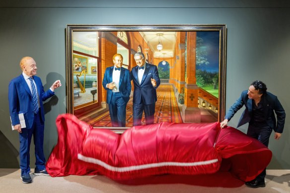 Anthony Pratt (left) and artist Ralph Heimans unveil a portrait of Pratt and his late father, Richard, at Visy headquarters in Melbourne.